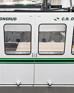 C.R. Onsrud 122E25 CNC machine featuring full enclosure with spindle doors closed for maximum operator safety and noise reduction during high-speed operations.