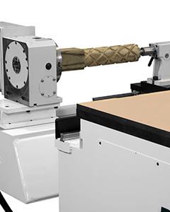 Close-up view of the lathe attachment on a C.R. Onsrud 145G18 CNC router used for turning and machining cylindrical parts.