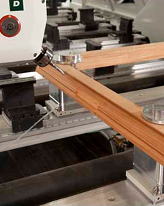 Pod and rail system close-up highlighting the precision hold of wooden parts on a C.R. Onsrud CNC machine.