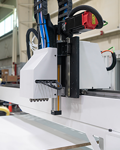 ReaJet Labeler attached to a CNC machine for automated part labeling and identification.