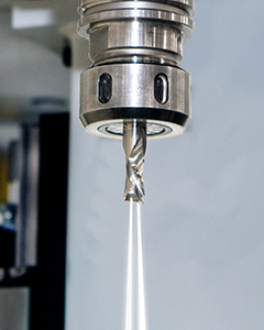 Close-up of a CNC machine spindle utilizing thru tool coolant technology for precision machining.