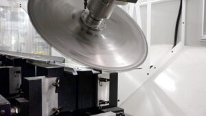 High-speed circular saw bevel-cutting extruded aluminum on a C.R. Onsrud X-Series CNC machine.